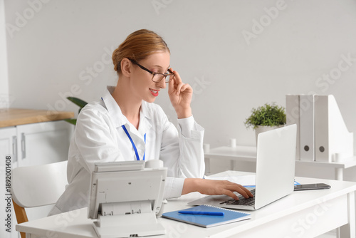 Happy female doctor working...