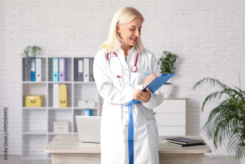 Female doctor writing in cl...