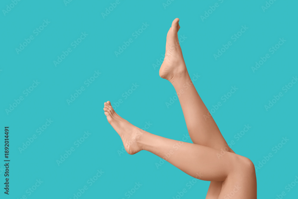 © Pixel-Shot - Legs of beautiful young woman after depilation on turquoise background