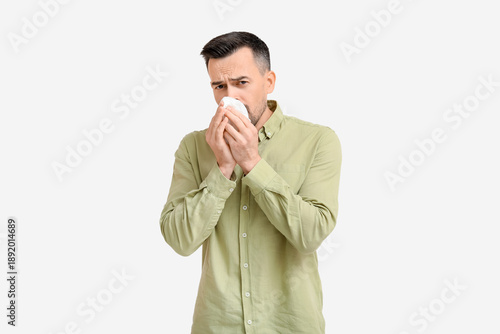 Sick young man with tissue ...