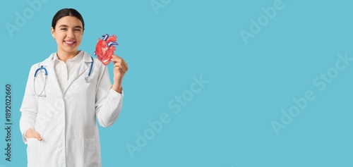 Female cardiologist holding...