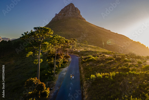 Stunning view of Lions Head with scenic road and hikers in Cape Town, South Africa at sunset