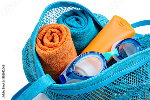 Blue mesh beach bag filled with colorful towels swimming goggles and sunscreen bottle isolated on a white background representing summer holiday vacation travel