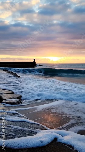 Wallpaper Mural Sunrise over the ocean with waves crashing on a rocky shoreline and pier Torontodigital.ca