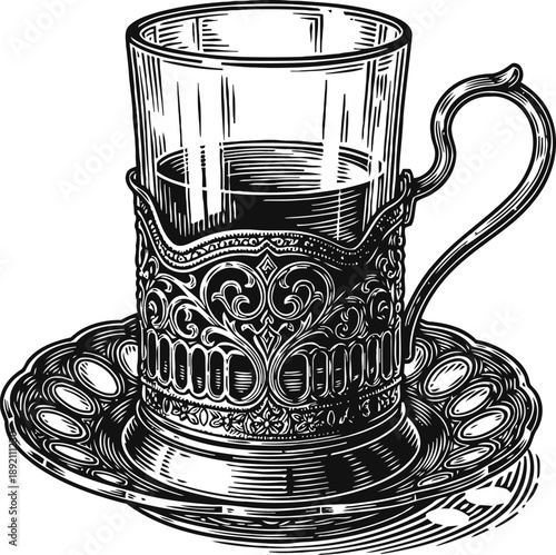 Elegant vintage glass cup with ornate metal holder and matching saucer in detailed engraving