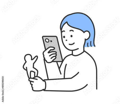 スマートフォンでアクリルスタンドを撮影する女性のイラスト　ベクター