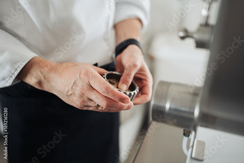 Skilled chef adjusts extruder to achieve perfect pasta slices