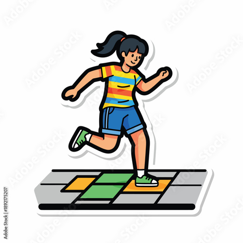 A girl plays on a colorful floor