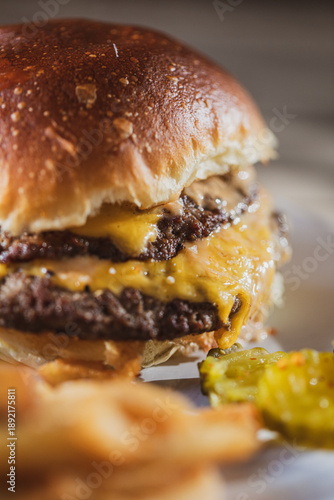 Smash burger with cheese on a restaurant patio 