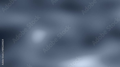 Blurred blue-toned surface with soft gradients and indistinct shapes, no clear subject visible. hazy
