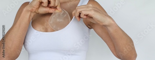 Wallpaper Mural A woman demonstrates the process of breast augmentation using a silicone implant concept Torontodigital.ca