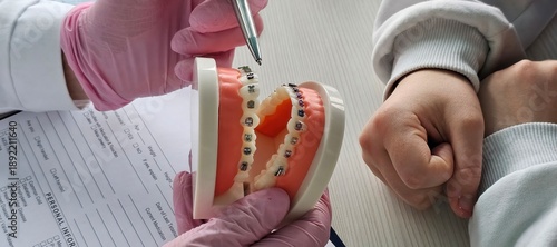 Wallpaper Mural Demonstration of dental braces on a model during an orthodontic consultation for patient Torontodigital.ca