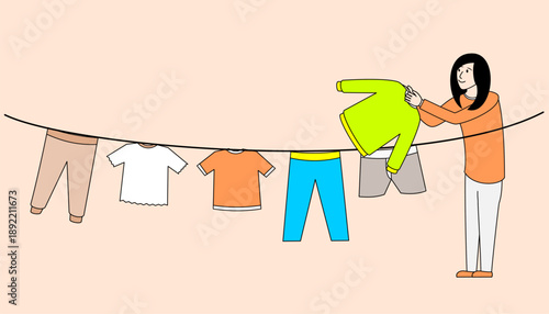 Woman is hanging up her clothes on a clothesline