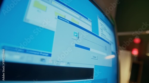No people close-up of blinking screen of vintage desktop computer monitor, with program establishing dial-up internet connection, in study or living room at home