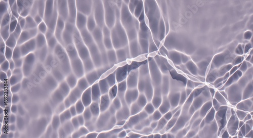 Wavy light caustics on lilac water surface, abstract background texture.