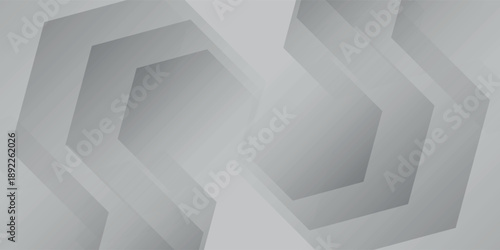 Abstract geometric pattern with repeating hexagonal shapes in shades of grey and white, creating a modern and minimalist background.