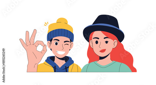 Happy young couple portrait, with the man in a beanie winking and giving an okay sign, and the woman smiling in a stylish hat.