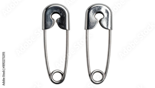 Two metal safety pins, close-up, isolated on a black background
