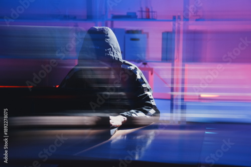 Hacker in Dark Room with Motion Blur Effect Representing Cyber Threats
