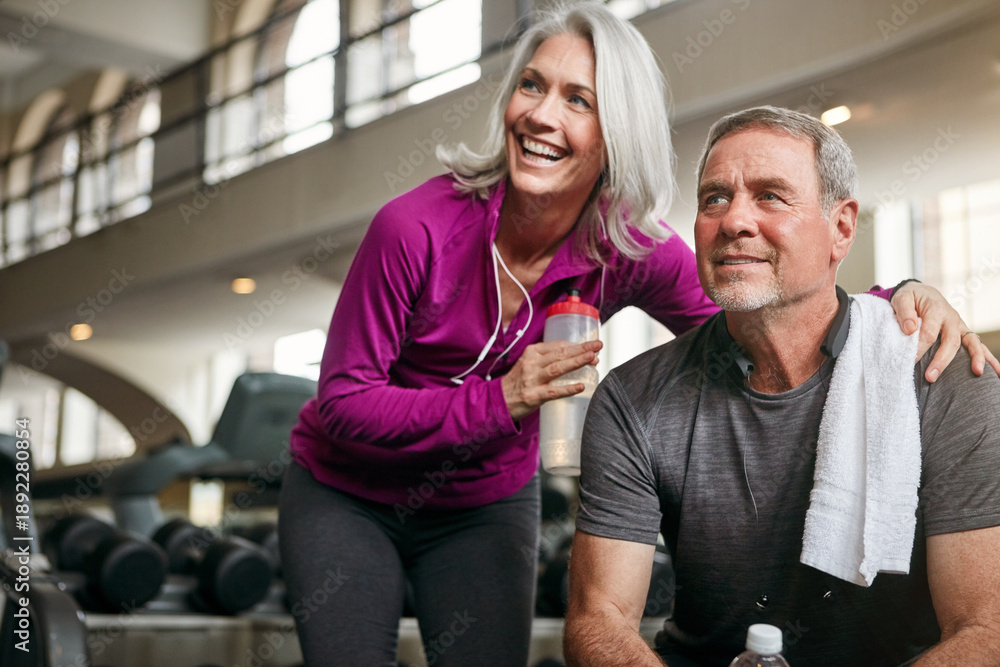 Fototapeta premium Smile, fitness and mature couple in gym with water, break or bonding for morning cardio. Senior people, man and woman for wellness, exercise and retirement health in sports club together for training