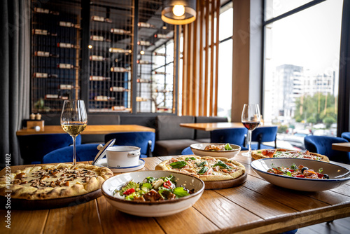 Modern Italian Restaurant Table with Pizza and Wine