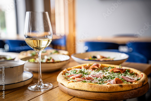 White Wine and Pizza on Restaurant Table