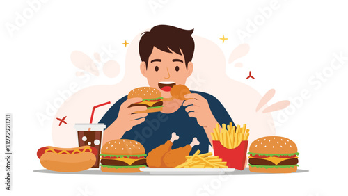 Happy young man indulging in a large feast of fast food including burgers, fried chicken, hot dogs, french fries, and a large soda.