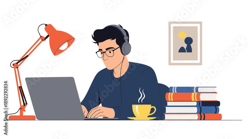Focused student wearing headphones and glasses while working on a laptop at a desk stacked with books and a steaming cup of coffee.