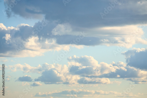 Sunbeams break dramatically through dense clouds in the blue sky.