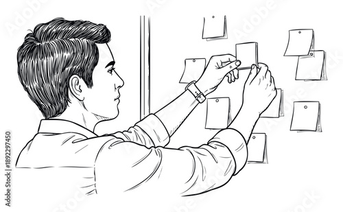 Focused male professional actively arranging sticky notes on a wall, symbolizing effective project planning, task organization, and creative brainstorming sessions.