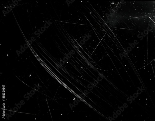 A black background with scattered white scratches and marks