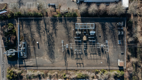 Canvas Print Aerial top down photo of an electric power substation with nearby cellular commu