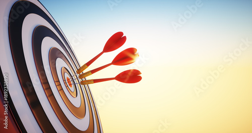 Tableau sur toile Close up shot of red three dart arrows hit on bullseye of dartboard in bright su