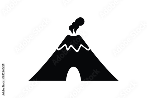 Volcano eruption smoke emanating from summit with cave opening at base silhouette