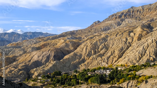 Fotografie Remote village nestled in the arid mountains of Upper Mustang