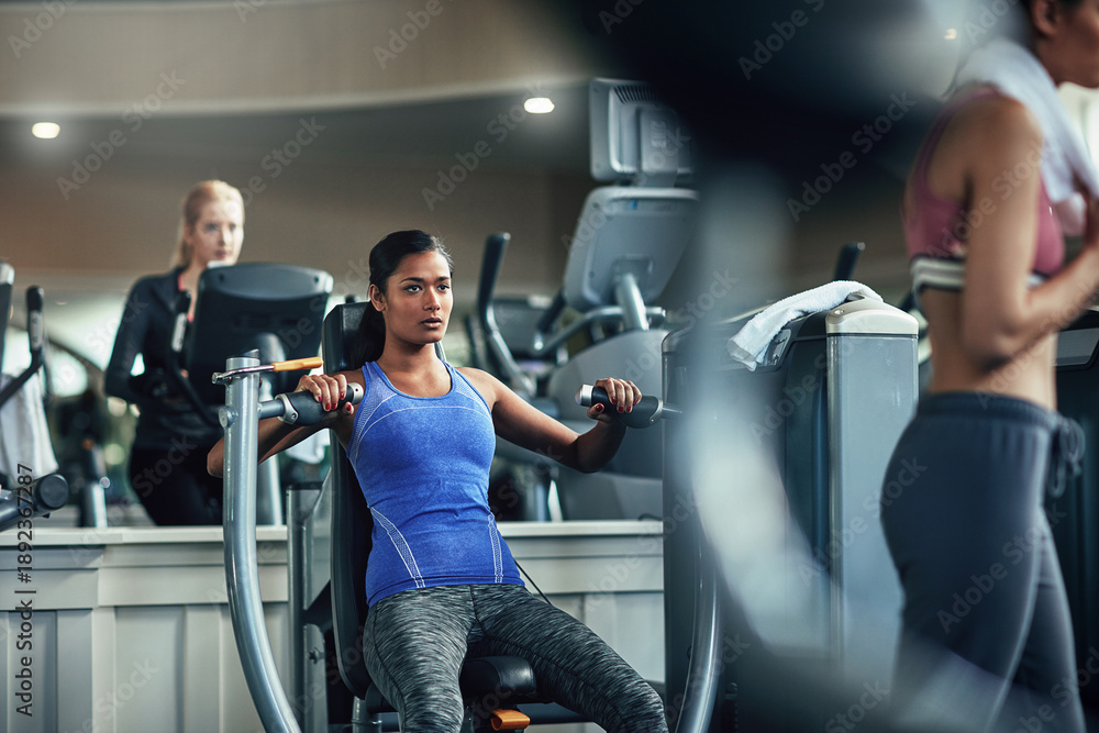 Fototapeta premium Fitness, weightlifting and woman in gym with endurance, training and chest press machine. Workout, wellness and athlete in club with weights, exercise and body strength for muscle transformation