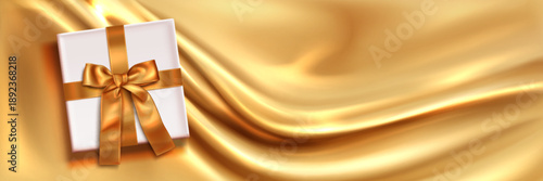 Golden silk flowing background with white gift box and satin ribbon with bow, realistic vector illustration. Elegant velvet bg, top view. Premium present banner for birthday celebration, special event
