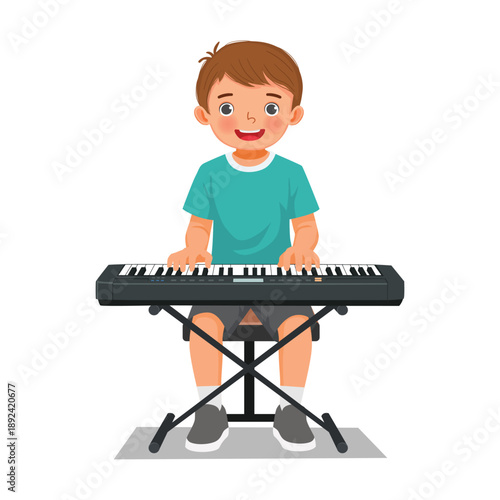 Little boy playing electric piano or keyboard 