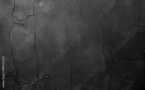 Dark cement wall in retro concept. Black concrete background for wallpaper or graphic design. Blank old plaster texture in vintage style. Abstract surface with unusual beautiful patterns.