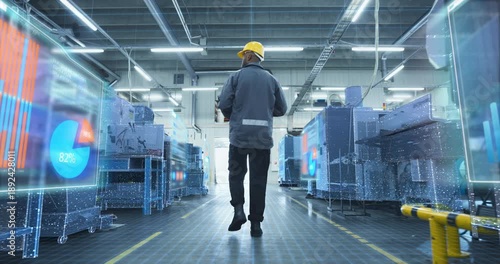 Wallpaper Mural Factory Engineer Walks Through Production Factory as Holographic Overlays Machines, Data Grids, Visualizing Industry 4.0 Monitoring, Predictive Maintenance, Smart Manufacturing Analytics  Torontodigital.ca