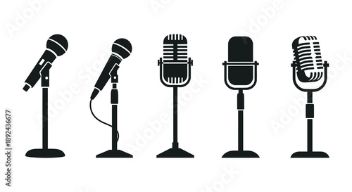 A collection of five vintage style microphones in a stark black presentation a dramatic silhouette high quality professional