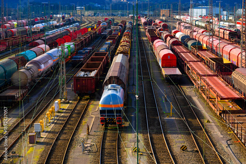 The freight station in Hagen-Vorhalle is one of the largest facilities of its kind in Europe. Here, trains are divided and reassembled on countless parallel tracks. Panorama with colourful wagons.