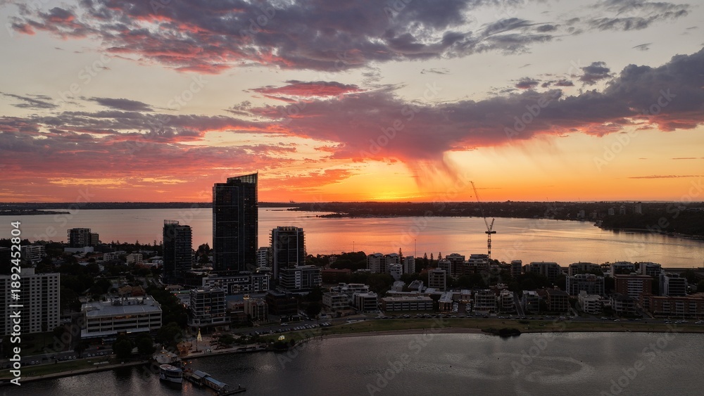 Naklejka premium Sunset over Perth City CBD, Western Australia – aerial view of skyline, modern skyscrapers, urban cityscape and golden evening light