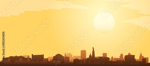 Golden yellow panoramic poster of the city skyline with misty background buildings and clouds of LODZ, POLAND