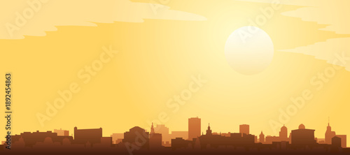 Golden yellow panoramic poster of the city skyline with misty background buildings and clouds of KRAKOW, POLAND