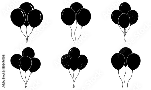 Collection of black balloons in various groupings floating in the air, illustrating celebrations and festive atmosphere
