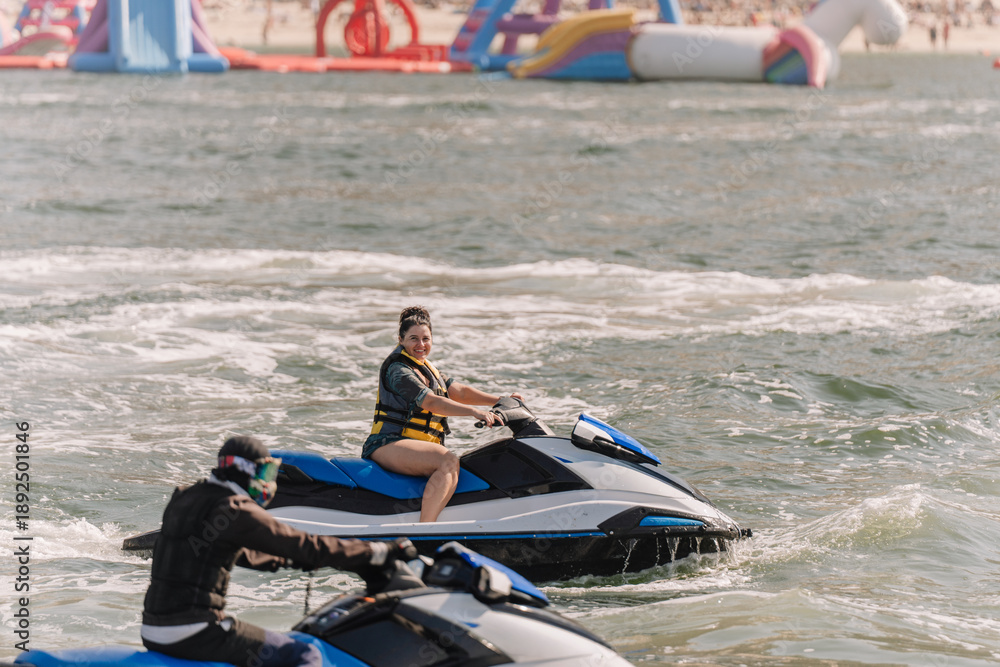 Ταπετσαρία Two individuals riding jet skis on a water surface with inflatable water park st