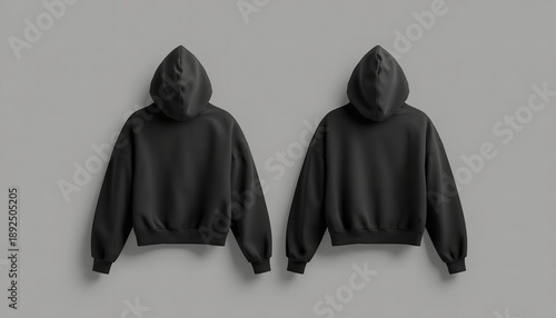 Two black hooded sweatshirts displayed on a gray background for fashion or apparel design purposes