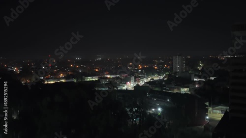 Wallpaper Mural Night drone ascends over Avenida Misiones, Puerto Iguazú with street and shop lights Torontodigital.ca
