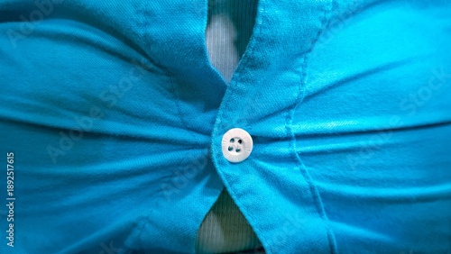 Fotografija Close up of tight blue shirt button straining from overweight